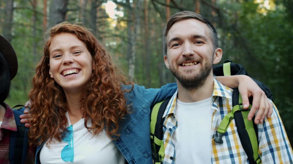 Two people hiking a forest trail